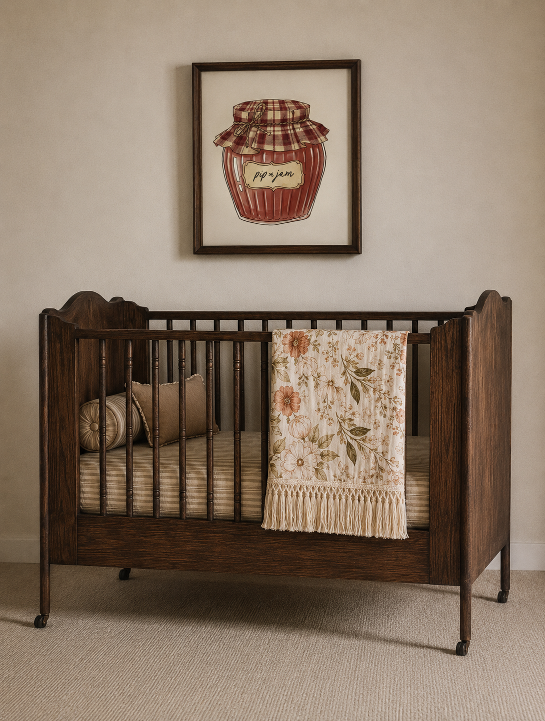 Wooden crib with cottage floral blanket in a room with a framed picture on the wall.