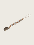 Pacifier clip with certified wooden and grey beads on a beige background | Pip & Jam
